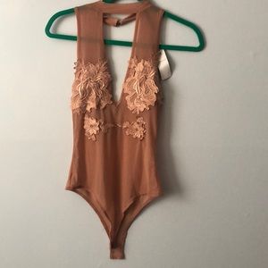 New bodysuit is a clear or transparent material.